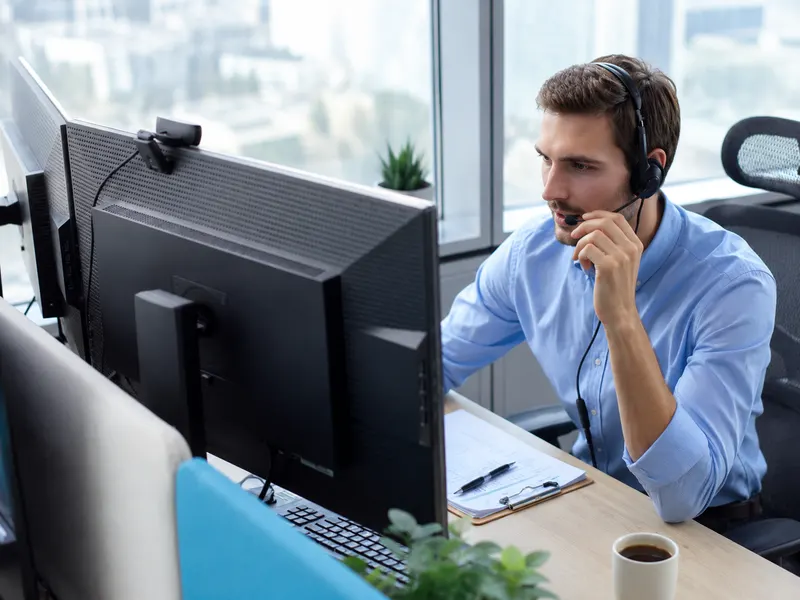 Support technician with headset helping a remote user